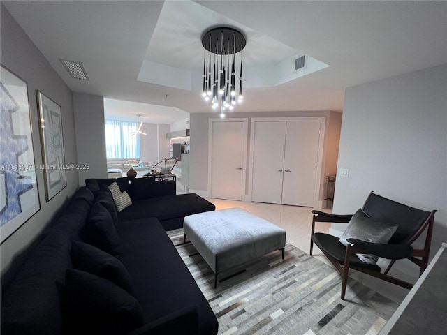 17301 Biscayne Blvd Unit 1402, North Miami Beach, FL 33160 - living room featuring a tray ceiling and a chandelier