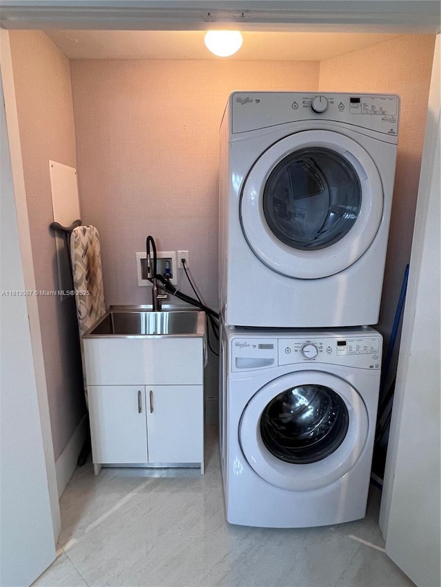 17301 Biscayne Blvd Unit 1402, North Miami Beach, FL 33160 - laundry room with stacked washer / drying machine and cabinet space