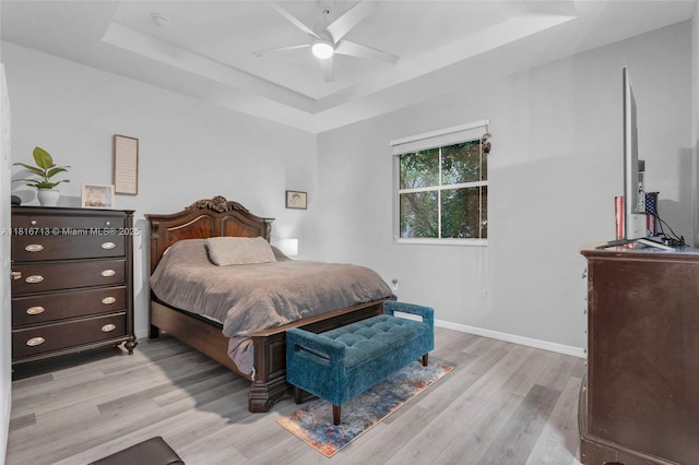 14063 SW 49th Ct Unit 4, Miramar, FL 33027 - bedroom with a raised ceiling, light wood finished floors, baseboards, and ceiling fan