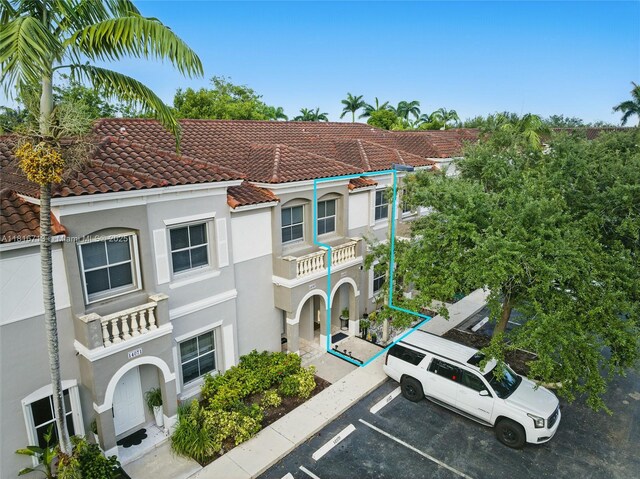 14063 SW 49th Ct Unit 4, Miramar, FL 33027 - view of front of property featuring a tiled roof, uncovered parking, and stucco siding
