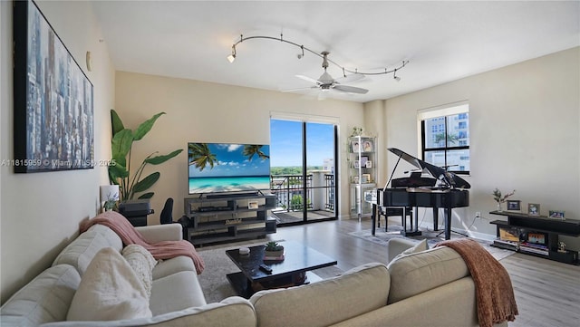 8390 SW 72nd Ave Unit 811, Miami, FL 33143 - living area featuring plenty of natural light, wood finished floors, a ceiling fan, and rail lighting