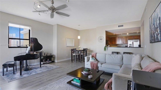 8390 SW 72nd Ave Unit 811, Miami, FL 33143 - living area featuring rail lighting, light wood-style floors, a ceiling fan, and baseboards