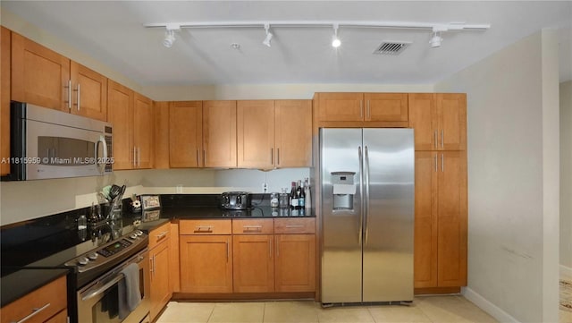 8390 SW 72nd Ave Unit 811, Miami, FL 33143 - kitchen with appliances with stainless steel finishes, rail lighting, dark countertops, and light tile patterned floors