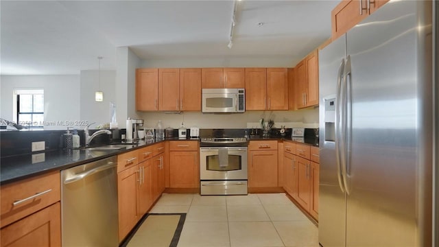 8390 SW 72nd Ave Unit 811, Miami, FL 33143 - kitchen with appliances with stainless steel finishes, a sink, dark countertops, light tile patterned floors, and pendant lighting