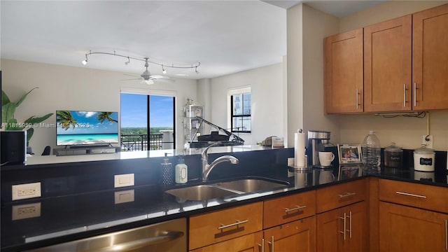 8390 SW 72nd Ave Unit 811, Miami, FL 33143 - kitchen with a sink, stainless steel dishwasher, brown cabinetry, a ceiling fan, and dark countertops