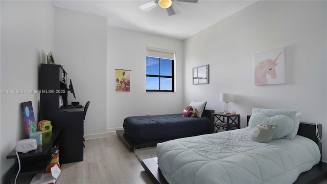 8390 SW 72nd Ave Unit 811, Miami, FL 33143 - bedroom with light wood-style flooring, a ceiling fan, and baseboards