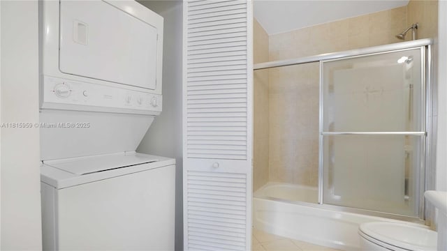 8390 SW 72nd Ave Unit 811, Miami, FL 33143 - bathroom featuring stacked washer / dryer, a closet, enclosed tub / shower combo, and toilet