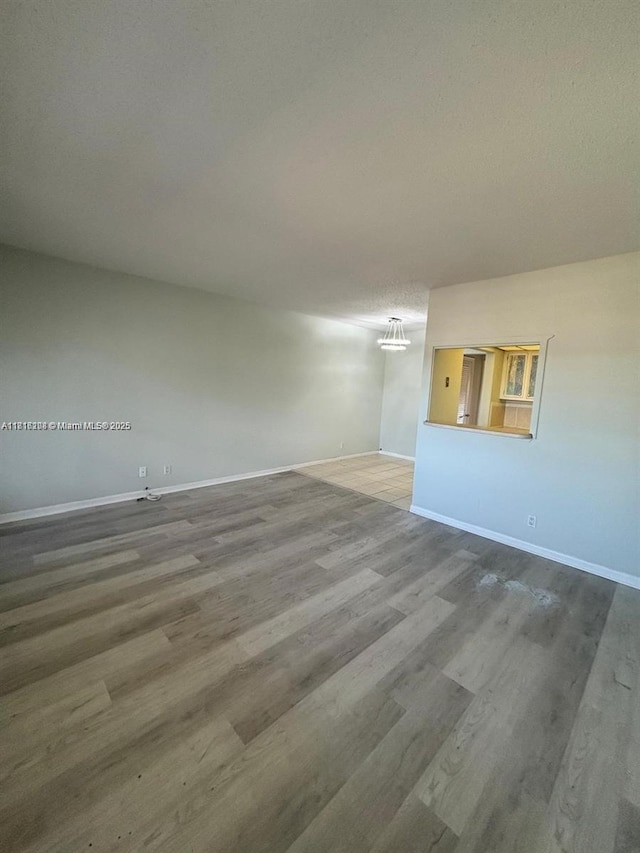 119 E Salisbury Unit E, West Palm Beach, FL 33417 - unfurnished room featuring baseboards and wood finished floors