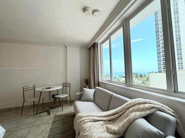 19201 Collins Ave Unit 303, Sunny Isles Beach, FL 33160 - living area featuring crown molding, light tile patterned floors, baseboards, and a textured ceiling