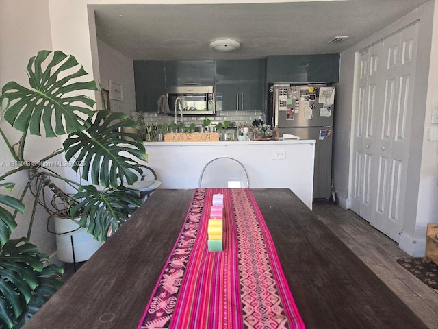 4560 SW 68th Ct Cir Unit 61-9, Miami, FL 33155 - kitchen featuring stainless steel appliances, wood finished floors, and tasteful backsplash