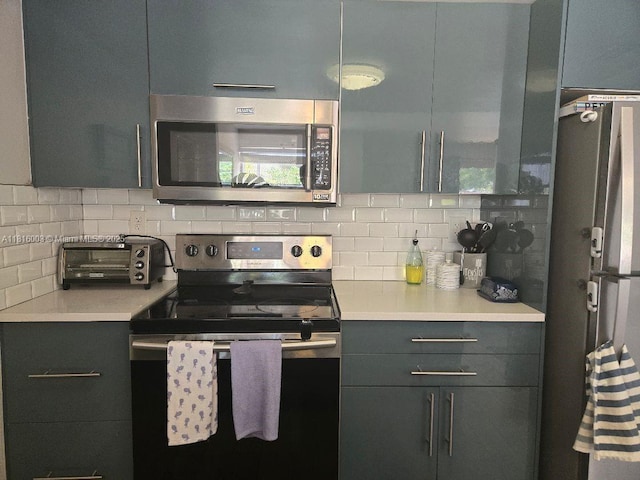 4560 SW 68th Ct Cir Unit 61-9, Miami, FL 33155 - kitchen featuring stainless steel appliances, backsplash, light countertops, and gray cabinetry