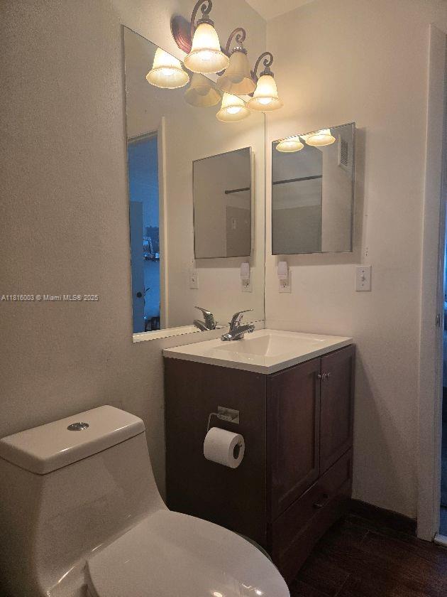 4560 SW 68th Ct Cir Unit 61-9, Miami, FL 33155 - half bathroom with toilet, vanity, and wood finished floors