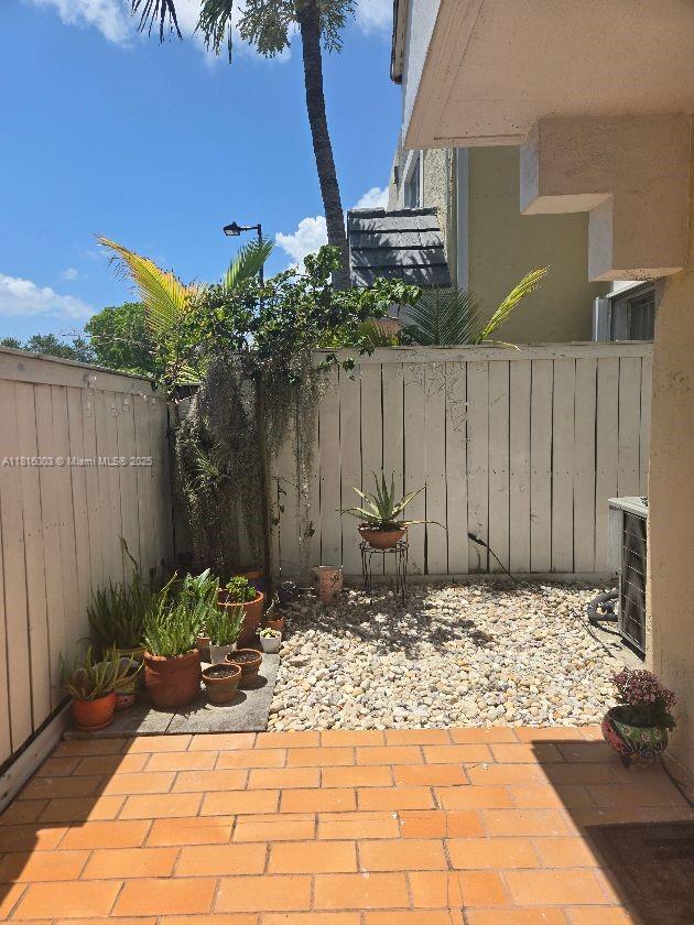 4560 SW 68th Ct Cir Unit 61-9, Miami, FL 33155 - fenced backyard featuring a patio area and central air condition unit