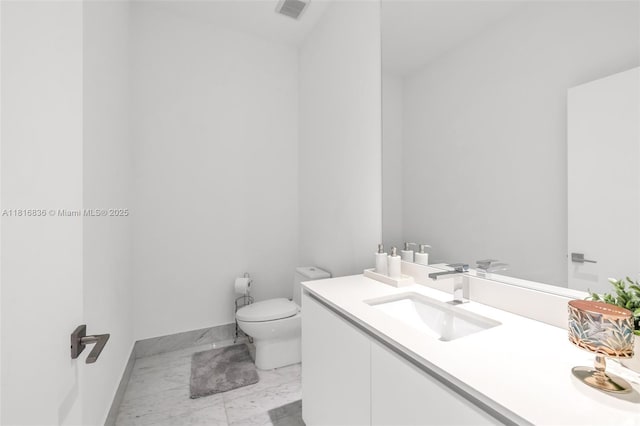 650 NE 32nd St Unit Bh4, Miami, FL 33137 - bathroom with marble finish floors, toilet, vanity, and baseboards