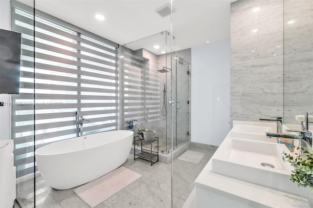 650 NE 32nd St Unit Bh4, Miami, FL 33137 - full bath with a stall shower, a soaking tub, marble finish floors, double vanity, and tile walls