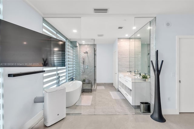 650 NE 32nd St Unit Bh4, Miami, FL 33137 - bathroom with a freestanding tub, a shower stall, double vanity, recessed lighting, and baseboards