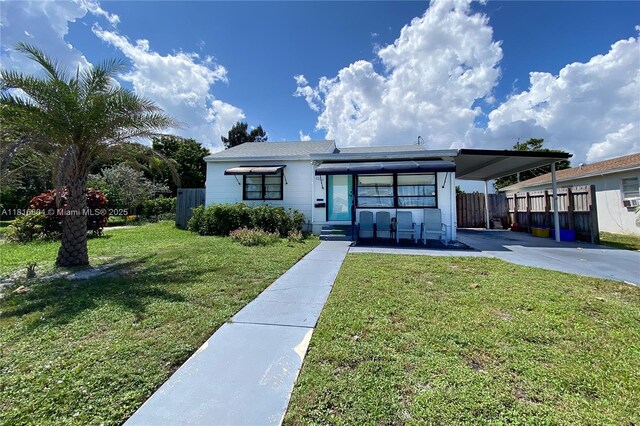1109 S M St, Lake Worth, FL 33460 - view of front of property with driveway and an attached carport