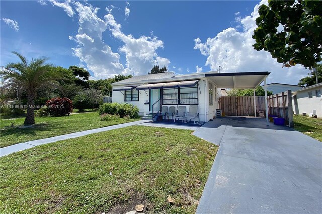 1109 S M St, Lake Worth, FL 33460 - manufactured / mobile home featuring driveway and a carport