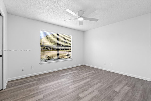 2094 Arbour Walk Unit 318, Naples, FL 34109 - empty room featuring wood finished floors, a textured ceiling, ceiling fan, and baseboards