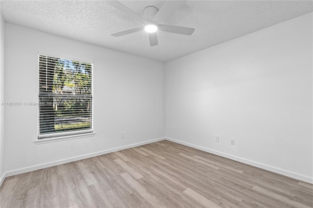 2094 Arbour Walk Unit 318, Naples, FL 34109 - spare room featuring wood finished floors, a textured ceiling, ceiling fan, and baseboards