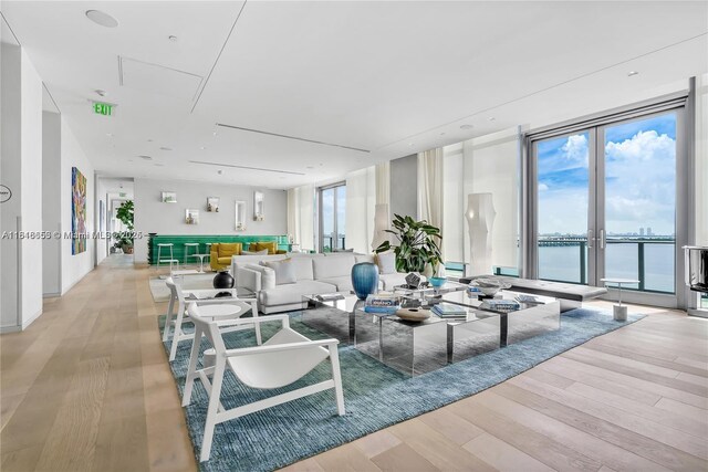 3131 NE 7th Ave Unit 1702, Miami, FL 33137 - living room with a wall of windows, light wood-type flooring, and a water view