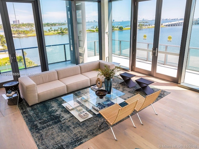3131 NE 7th Ave Unit 1702, Miami, FL 33137 - living room featuring french doors, healthy amount of natural light, and a water view