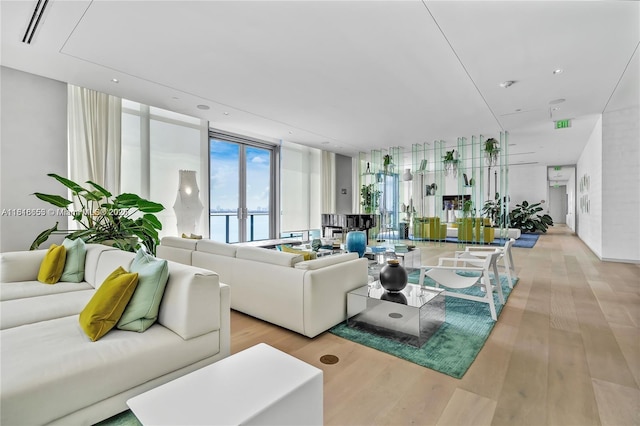 3131 NE 7th Ave Unit 1702, Miami, FL 33137 - living room with light wood-style floors, floor to ceiling windows, and recessed lighting