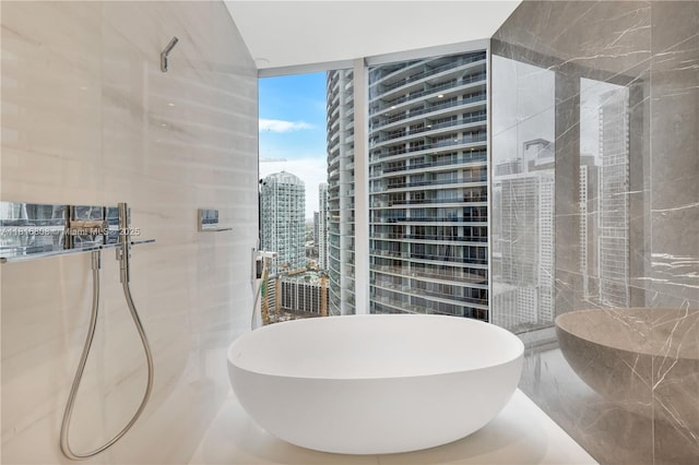 300 Biscayne Blvd Way Unit 2907, Miami, FL 33131 - full bath featuring a wall of windows, a freestanding tub, a view of city, and marble finish floors