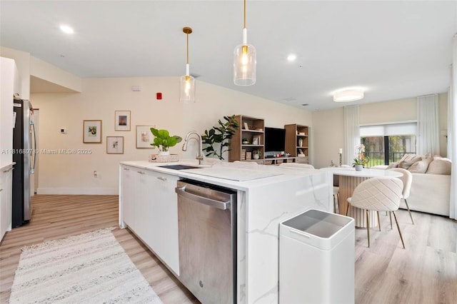 8001 NW 41st St Unit F-107, Doral, FL 33166 - kitchen with appliances with stainless steel finishes, a sink, open floor plan, light wood-style flooring, and a center island with sink