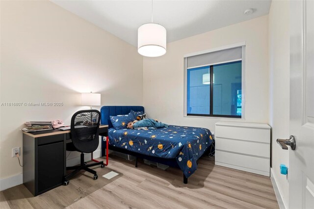 8001 NW 41st St Unit F-107, Doral, FL 33166 - bedroom featuring wood finished floors and baseboards