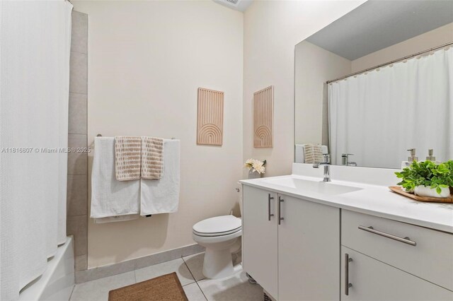 8001 NW 41st St Unit F-107, Doral, FL 33166 - bathroom featuring vanity, tile patterned flooring, toilet, baseboards, and shower / tub combo with curtain