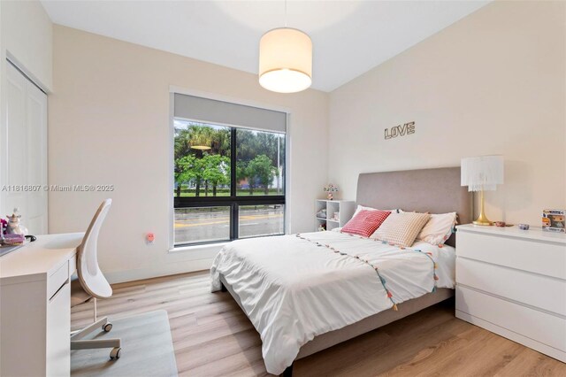 8001 NW 41st St Unit F-107, Doral, FL 33166 - bedroom with light wood-style floors and an office area