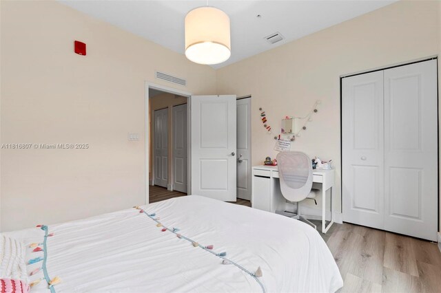 8001 NW 41st St Unit F-107, Doral, FL 33166 - bedroom with light wood finished floors and multiple closets