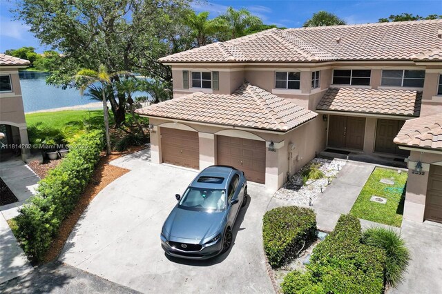 2388 NW 97th Way, Pembroke Pines, FL 33024 - mediterranean / spanish house featuring a tile roof, stucco siding, concrete driveway, and a garage