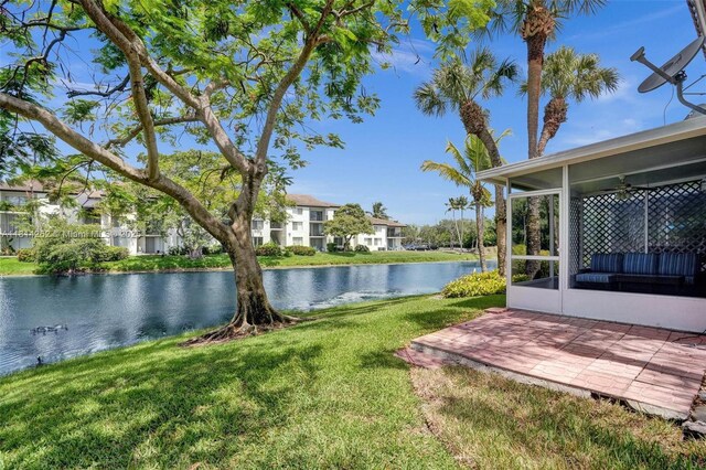 2388 NW 97th Way, Pembroke Pines, FL 33024 - view of grassy yard with a sunroom, a water view, ceiling fan, and a patio area