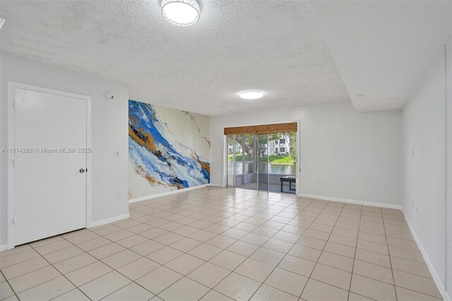 2388 NW 97th Way, Pembroke Pines, FL 33024 - empty room featuring a textured ceiling and light tile patterned floors