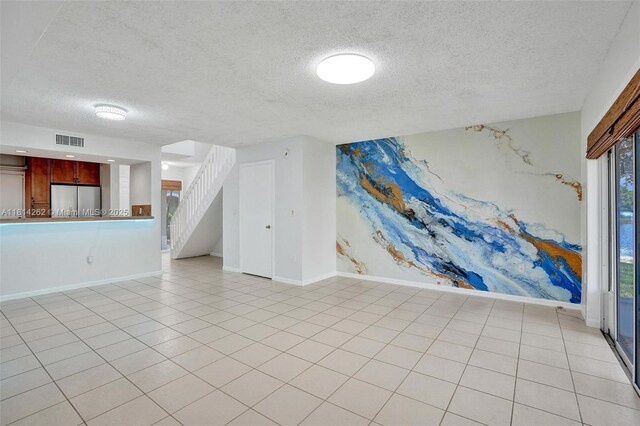 2388 NW 97th Way, Pembroke Pines, FL 33024 - unfurnished living room featuring a textured ceiling and stairs