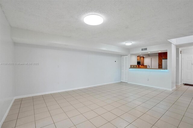 2388 NW 97th Way, Pembroke Pines, FL 33024 - empty room with a textured ceiling and light tile patterned flooring