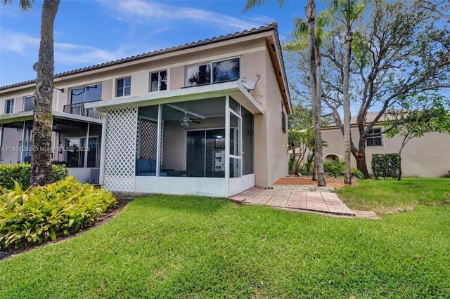 2388 NW 97th Way, Pembroke Pines, FL 33024 - back of property featuring a sunroom, stucco siding, a yard, and ceiling fan