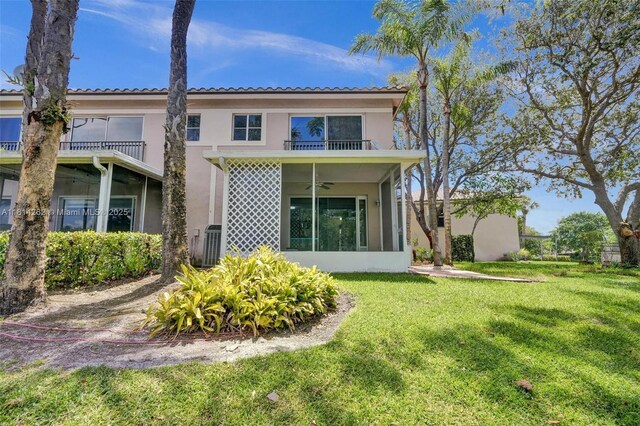 2388 NW 97th Way, Pembroke Pines, FL 33024 - back of property featuring stucco siding, a lawn, a balcony, ceiling fan, and a tile roof