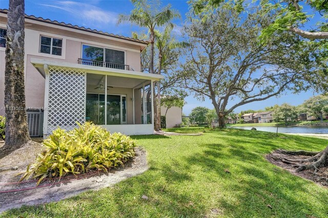 2388 NW 97th Way, Pembroke Pines, FL 33024 - rear view of house with a water view, stucco siding, a yard, a ceiling fan, and a balcony