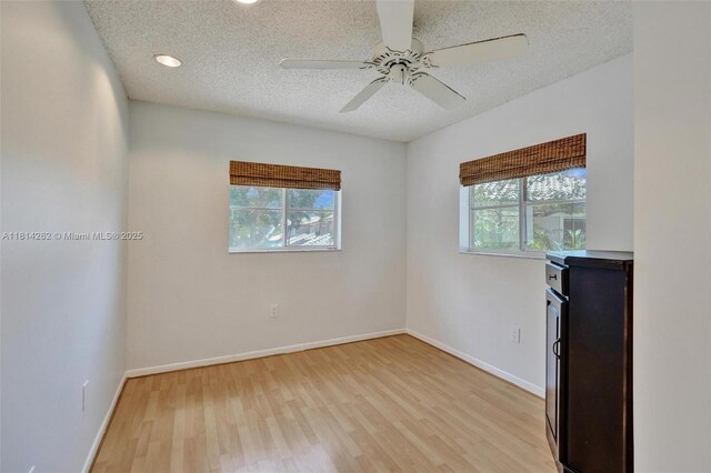 2388 NW 97th Way, Pembroke Pines, FL 33024 - spare room with light wood-type flooring, a textured ceiling, and ceiling fan