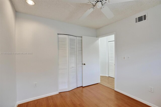 2388 NW 97th Way, Pembroke Pines, FL 33024 - unfurnished bedroom with wood finished floors, a closet, a ceiling fan, and a textured ceiling