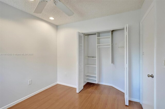 2388 NW 97th Way, Pembroke Pines, FL 33024 - unfurnished bedroom featuring light wood-type flooring, a closet, a textured ceiling, recessed lighting, and ceiling fan