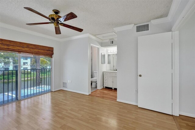 2388 NW 97th Way, Pembroke Pines, FL 33024 - unfurnished bedroom with access to outside, a textured ceiling, light wood-style flooring, ornamental molding, and connected bathroom
