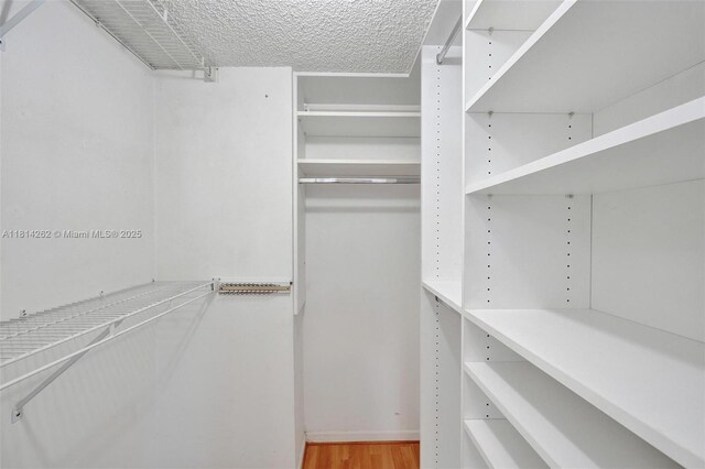 2388 NW 97th Way, Pembroke Pines, FL 33024 - walk in closet featuring wood finished floors
