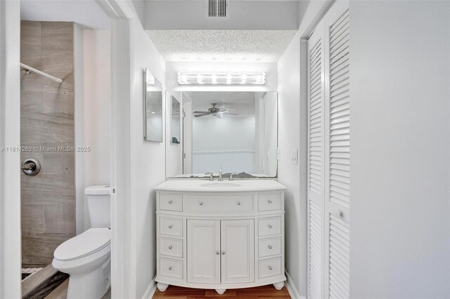 2388 NW 97th Way, Pembroke Pines, FL 33024 - bathroom with a closet, a tile shower, vanity, a ceiling fan, and a textured ceiling