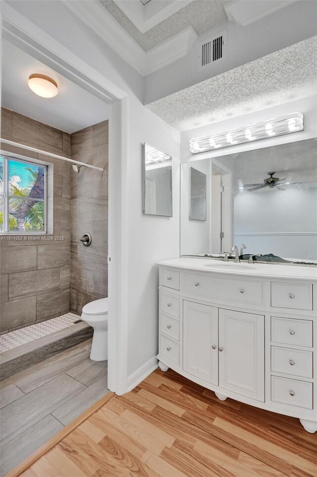 2388 NW 97th Way, Pembroke Pines, FL 33024 - bathroom with wood finished floors, a tile shower, a ceiling fan, and vanity