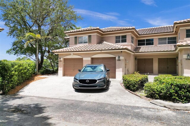 2388 NW 97th Way, Pembroke Pines, FL 33024 - view of front of home featuring stucco siding, driveway, a garage, and a tile roof