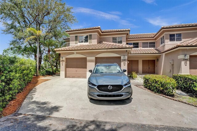 2388 NW 97th Way, Pembroke Pines, FL 33024 - view of front of house featuring concrete driveway, stucco siding, an attached garage, and a tile roof
